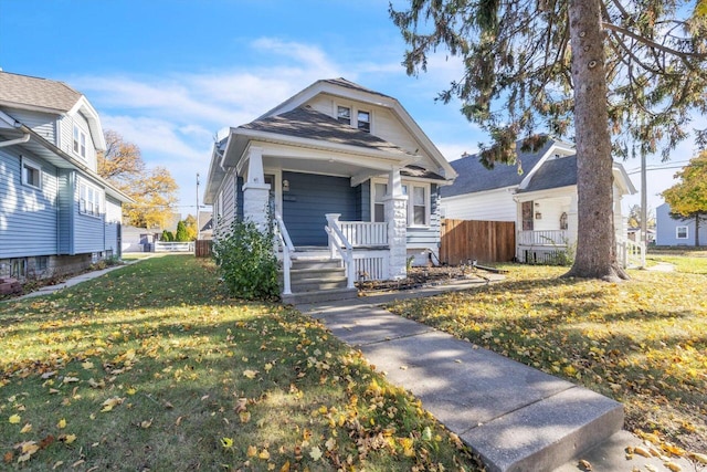 bungalow featuring a front lawn and a porch