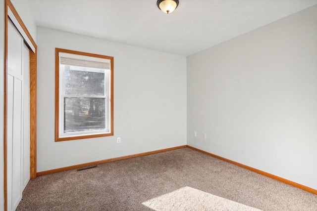 unfurnished bedroom with carpet floors and a closet