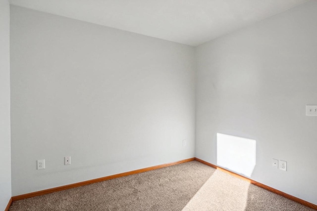 unfurnished room featuring carpet flooring