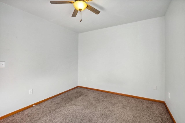 empty room with ceiling fan and carpet