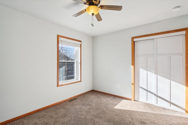 unfurnished bedroom with carpet floors, a closet, and ceiling fan