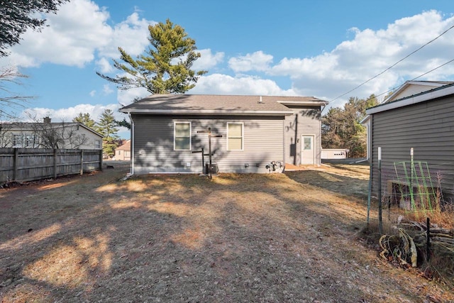 rear view of house featuring a lawn