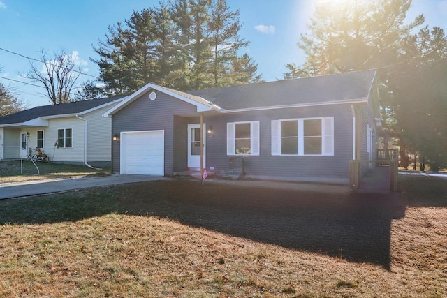 single story home featuring a garage and a front lawn