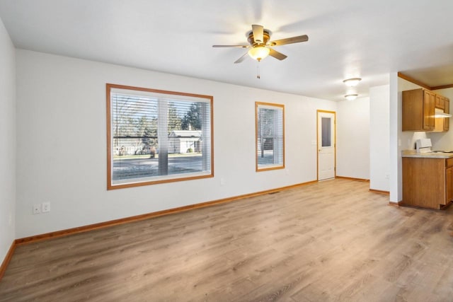 unfurnished living room featuring ceiling fan and light hardwood / wood-style floors