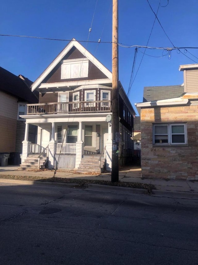 view of front of house featuring a porch and a balcony