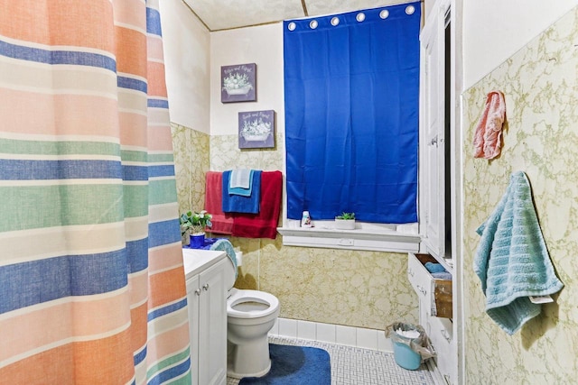 bathroom featuring tile patterned floors, vanity, and toilet