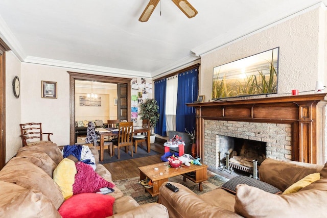 living room featuring ornamental molding, a brick fireplace, ceiling fan, and dark wood-type flooring