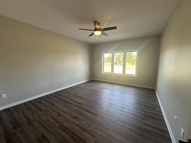 spare room with dark hardwood / wood-style floors and ceiling fan