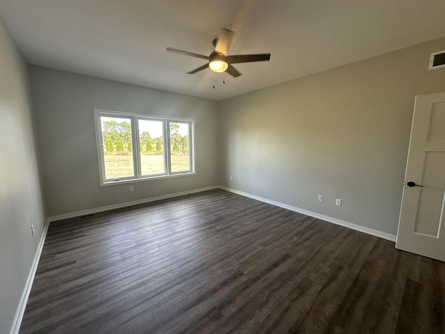 unfurnished room featuring ceiling fan and dark wood-type flooring