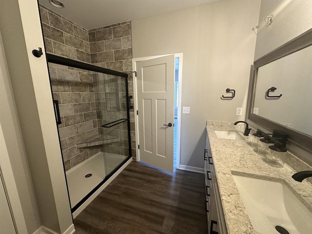 bathroom with vanity, hardwood / wood-style flooring, and walk in shower