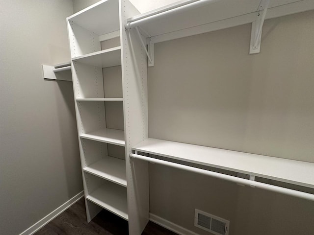 walk in closet featuring dark wood-type flooring