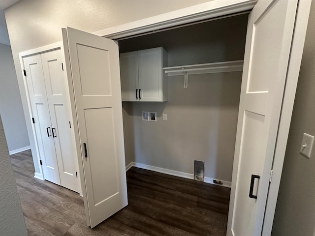 laundry area with washer hookup, dark hardwood / wood-style floors, and cabinets