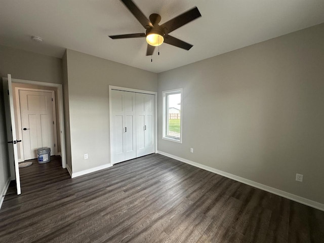 unfurnished bedroom featuring ceiling fan, dark wood-type flooring, and a closet