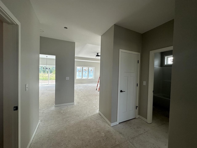 hall featuring a chandelier and plenty of natural light