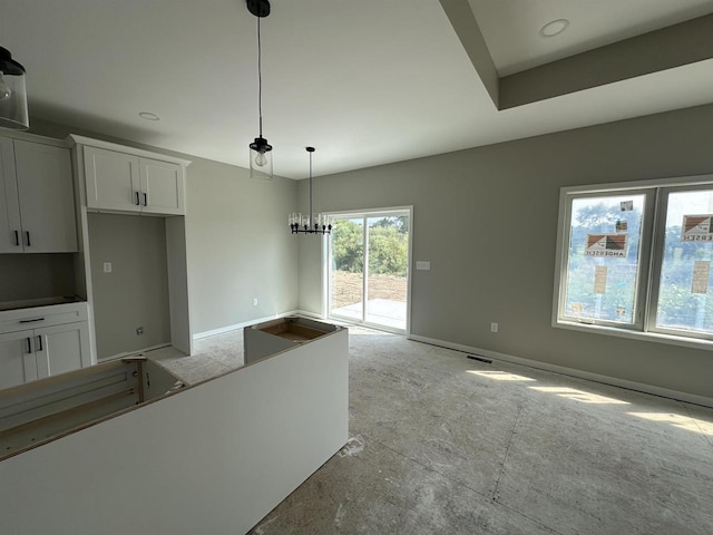 kitchen featuring white cabinetry, decorative light fixtures, and an inviting chandelier