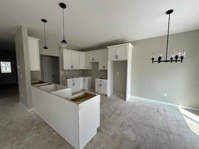 kitchen featuring white cabinetry, decorative light fixtures, and an inviting chandelier