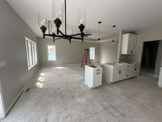 kitchen featuring white cabinets and ceiling fan with notable chandelier