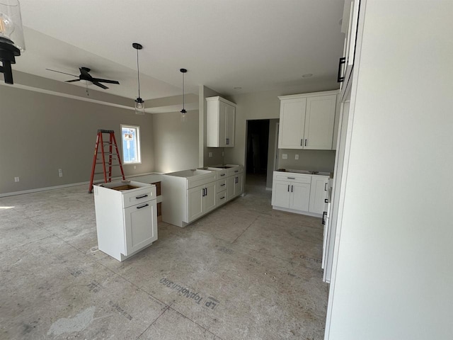 kitchen featuring white cabinets and ceiling fan