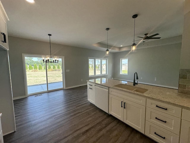 kitchen featuring light stone countertops, dishwasher, sink, dark wood-type flooring, and white cabinets