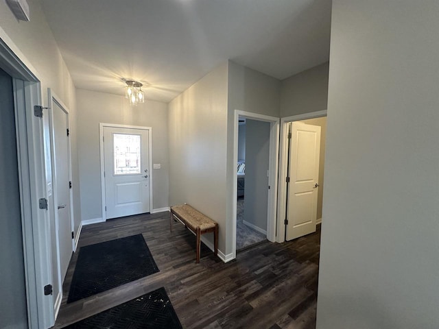 entrance foyer with dark hardwood / wood-style floors and a chandelier