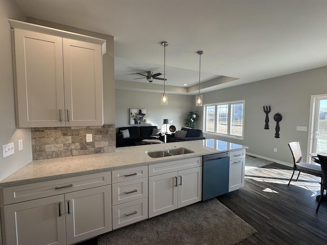 kitchen with white cabinets, dishwasher, and a wealth of natural light