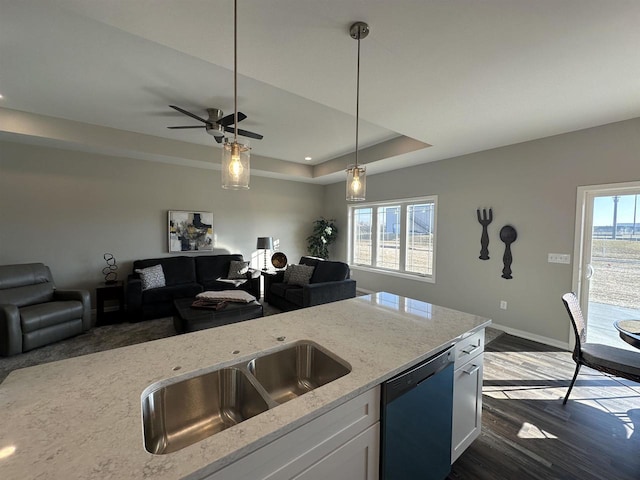 kitchen with white cabinetry, light stone countertops, dishwasher, and plenty of natural light