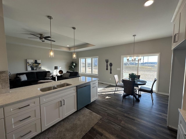 kitchen with white cabinets, stainless steel dishwasher, dark wood-type flooring, and light stone counters