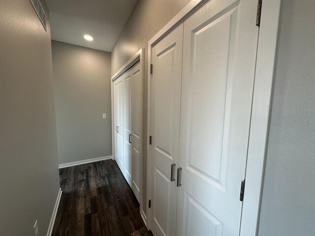 hallway featuring dark wood-type flooring