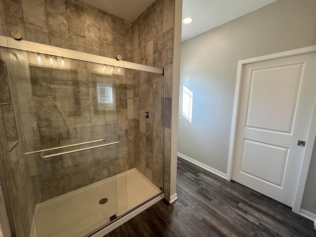 bathroom with wood-type flooring and walk in shower