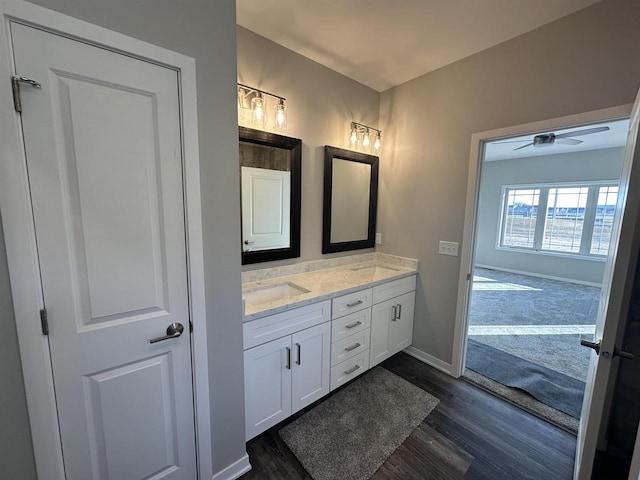 bathroom with wood-type flooring, vanity, and ceiling fan