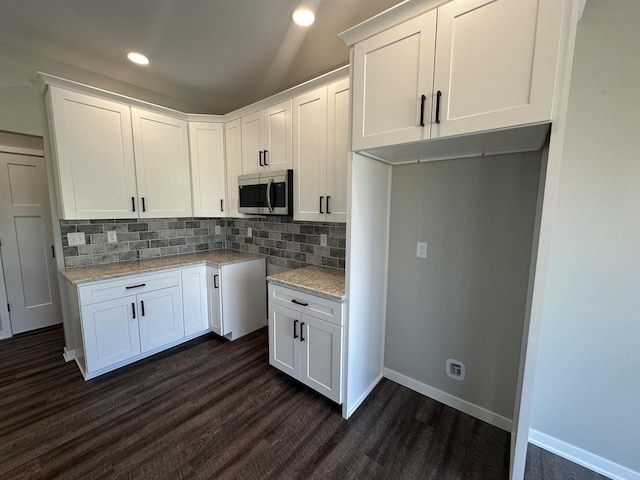 kitchen featuring tasteful backsplash, white cabinetry, and dark hardwood / wood-style flooring