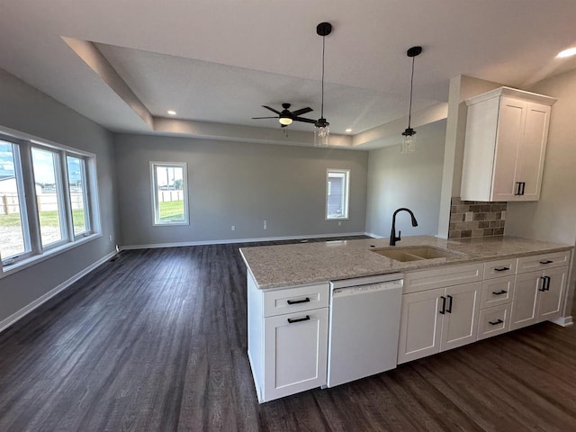 kitchen with white dishwasher, white cabinetry, sink, and dark wood-type flooring