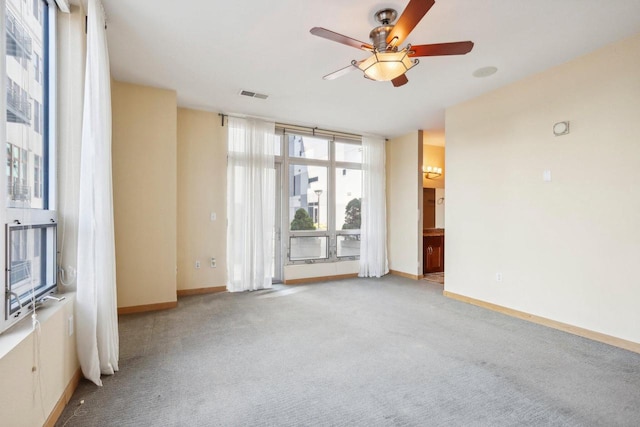 empty room with ceiling fan and light colored carpet