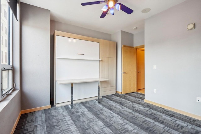 unfurnished bedroom featuring ceiling fan