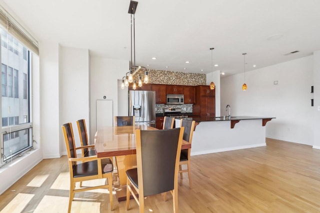 dining area featuring light hardwood / wood-style floors and sink