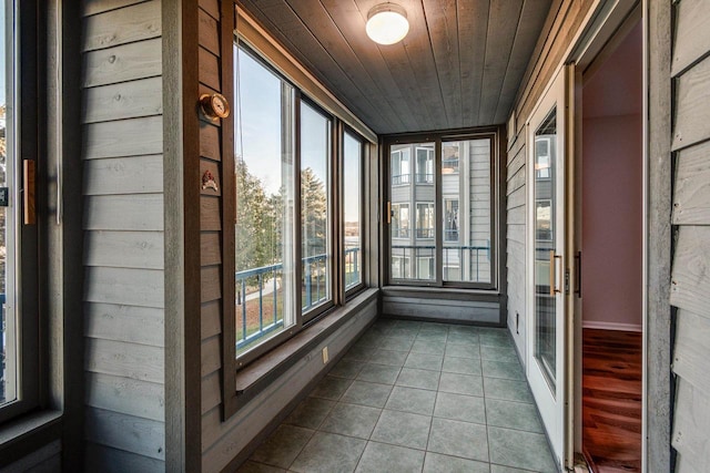 unfurnished sunroom with wooden ceiling