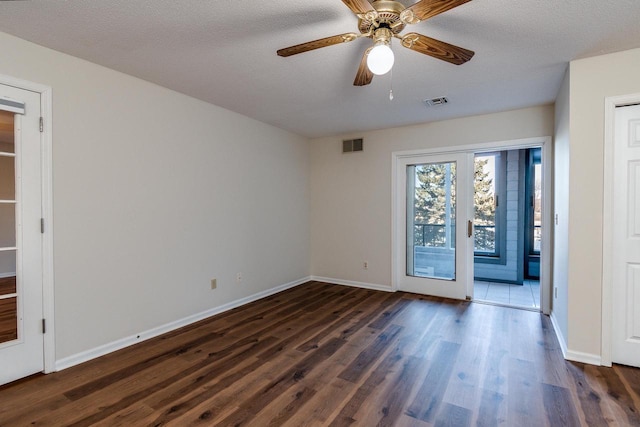 spare room featuring dark hardwood / wood-style floors, ceiling fan, a textured ceiling, and french doors