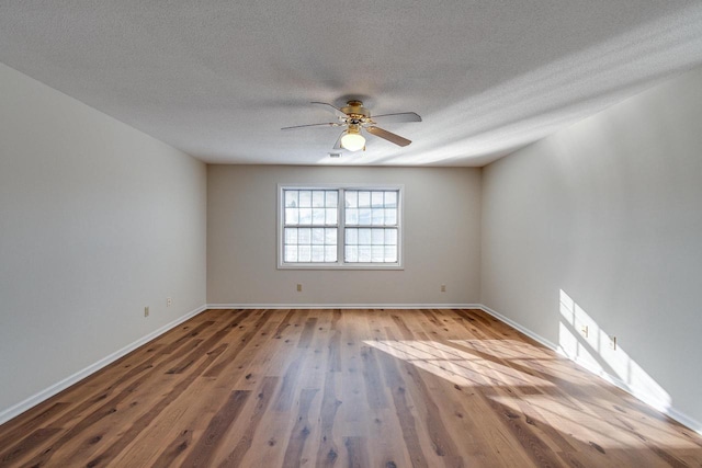 unfurnished room with wood-type flooring, a textured ceiling, and ceiling fan