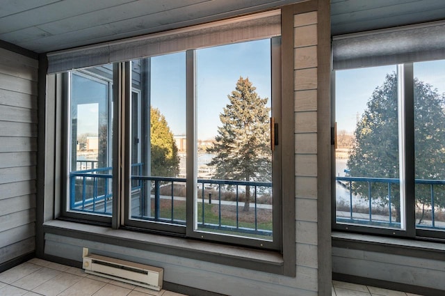 room details with wooden walls and a baseboard heating unit