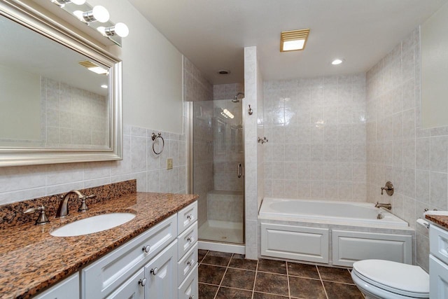 full bathroom featuring tile patterned floors, separate shower and tub, vanity, and tile walls