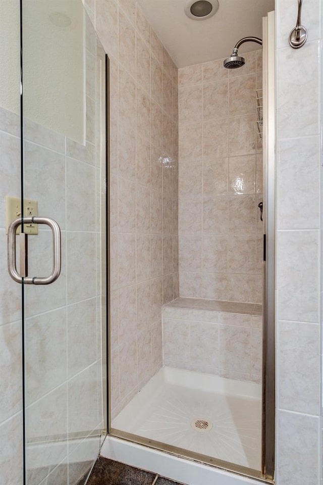 bathroom with tile walls and walk in shower