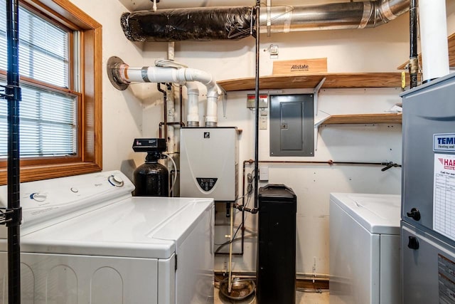 clothes washing area with separate washer and dryer and electric panel