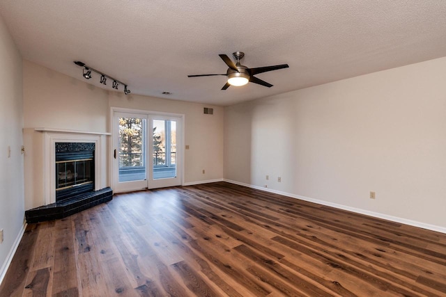 unfurnished living room featuring a textured ceiling, ceiling fan, and dark hardwood / wood-style floors