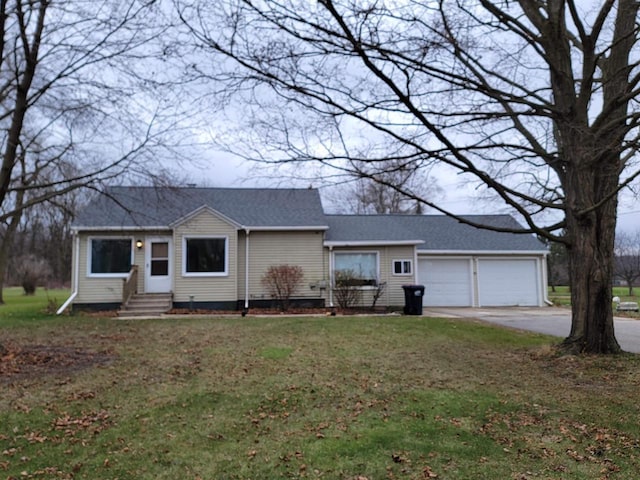 ranch-style house featuring a garage and a front lawn