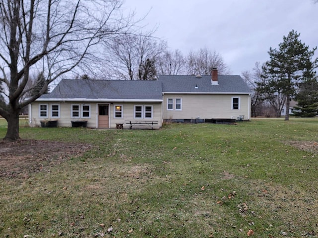 back of property featuring a lawn