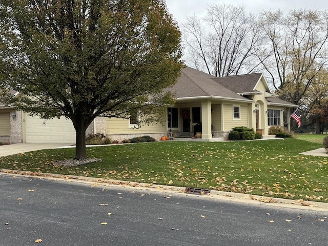 view of front of property featuring a garage and a front yard