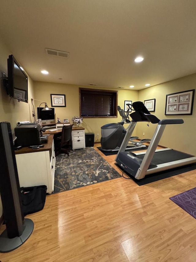 exercise area with light wood-type flooring