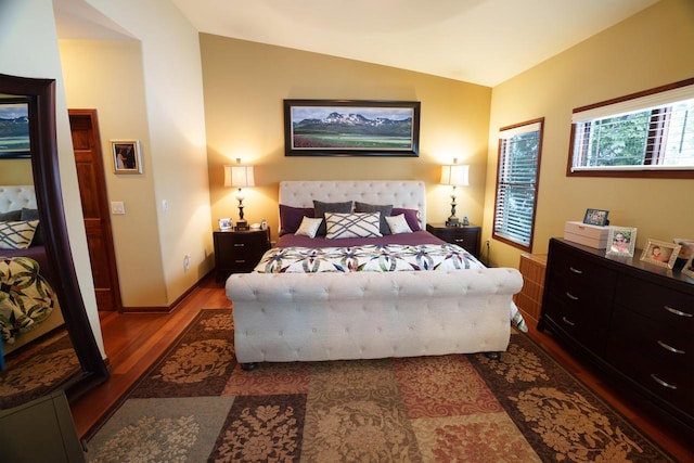 bedroom with wood-type flooring and vaulted ceiling