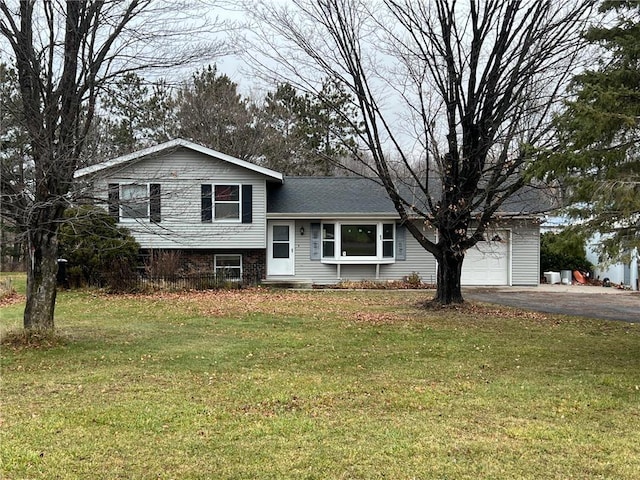 split level home featuring a front yard and a garage