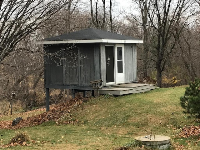 view of outdoor structure featuring a lawn